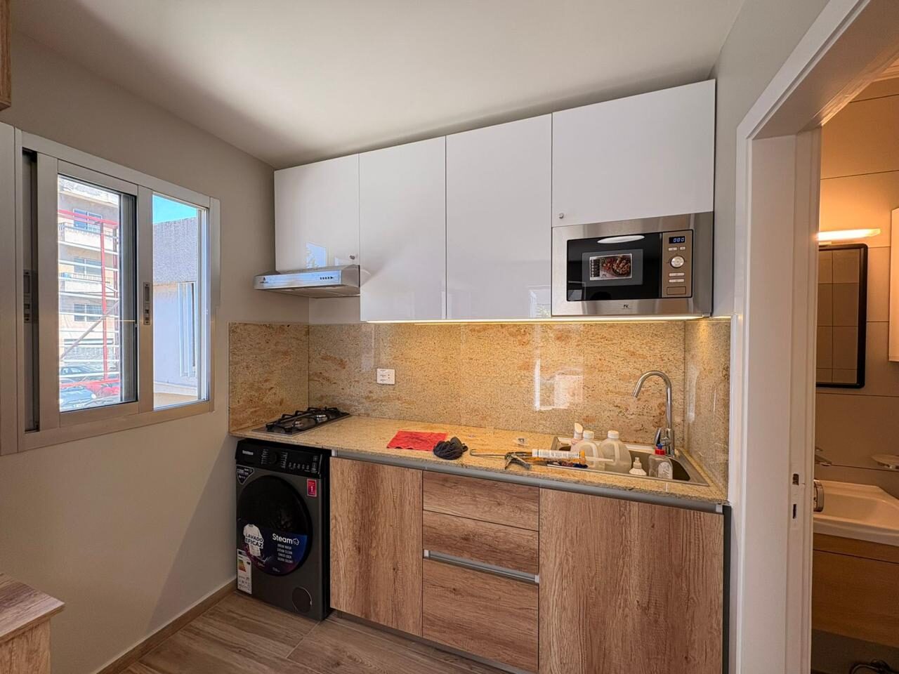 Studio kitchen with window and appliances