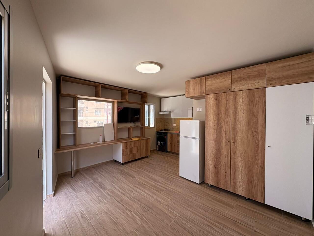 Furnished studio with wardrobe and shelving